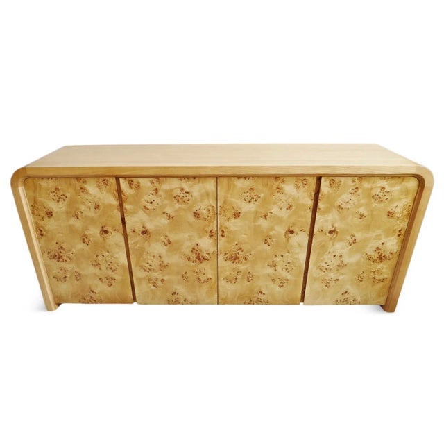 Beautiful modern burl wood sideboard. Rounded waterfall style shape with burl wood faced cabinet doors. Natural sealed oak...