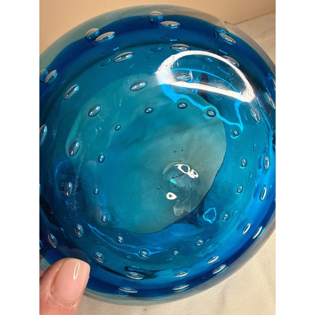 Elevate your tablescape or shelving display with this striking mid-century modern hand-blown art glass bowl/ashtray....