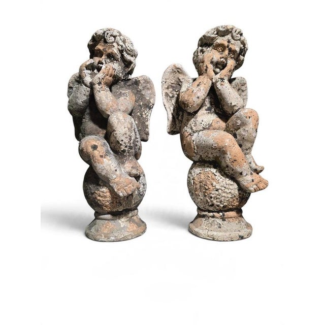 An elegant and highly decorative pair of 19th-century Italian terracotta cherub sculptures, beautifully modeled in the...