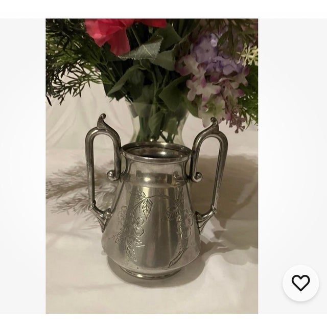 This cute flowered etched silver-plated tea set has a creamer, sugar bowl, & waste bowl. The company was organized as the...