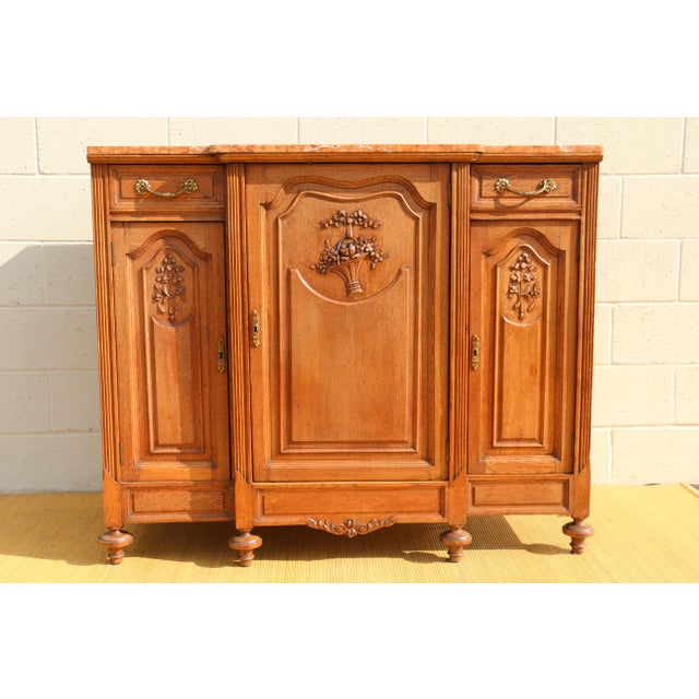Amazing Antique French buffet made of solid oak wood with marble top. It has two drawers and three doors with a single...