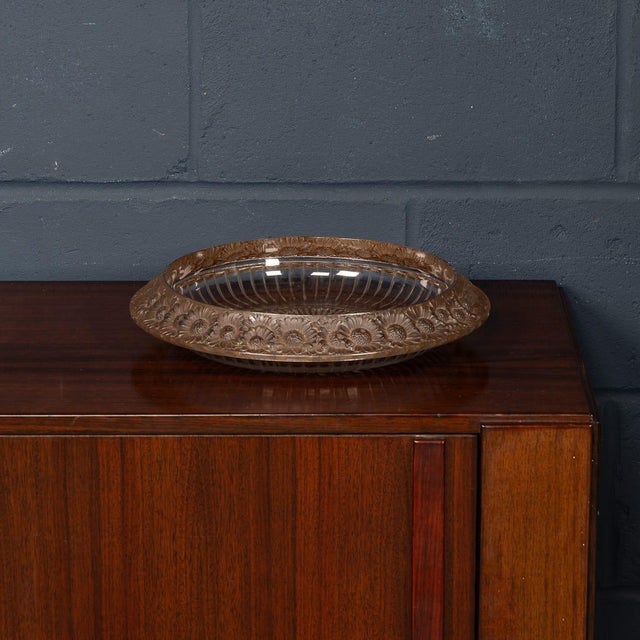 A refined moulded glass bowl from the marguerites series by rené lalique, produced by lalique in france. The bowl features...