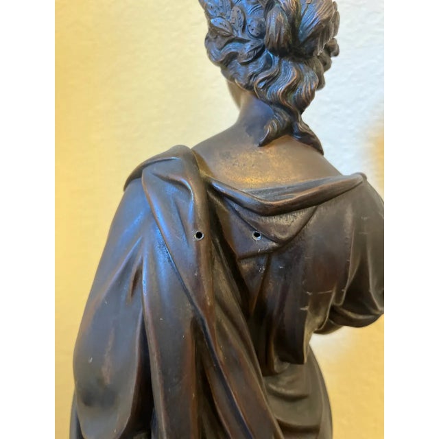 A striking neoclassical allegorical figure rendered in bronze-finished spelter, standing an impressive 25 inches tall. The...