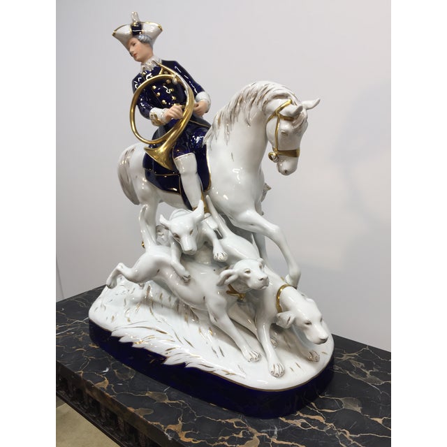 This large Royal Dux Fox Hunting Porcelain figure of the hunter and his hounds on horseback is in excellent original...
