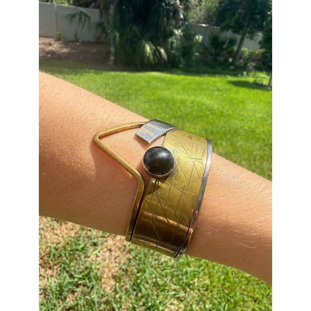 A striking vintage modernist cuff bracelet by American studio jeweler Hall McFall, featuring a sculptural mixed-metal...