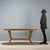 1960s vintage table featuring an elegant and functional design. The elliptical top is crafted from wood and treated glass,...
