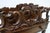 A finely carved raised mahogany Canterbury in the Rococo Revival taste, with turned spindles to the upper rails. The lower...