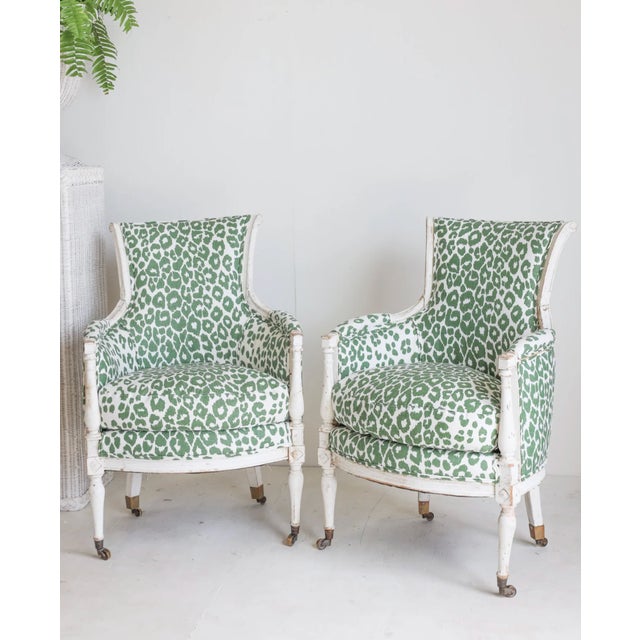 Elevate your space with the Remy Green Cheetah Chair, featuring an antique white painted frame, antique brass casters,...