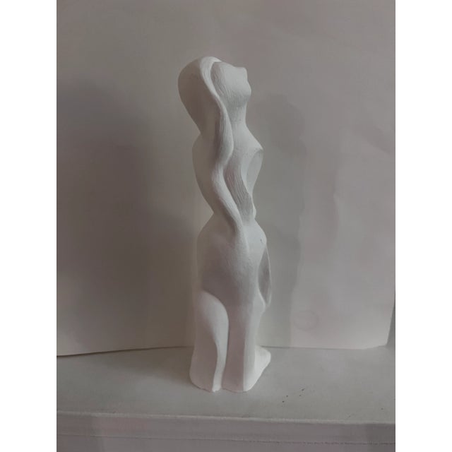 Fluid abstract forms make this sculpture Unique each way you turn it. Let your eye follow the curves that create shadows...