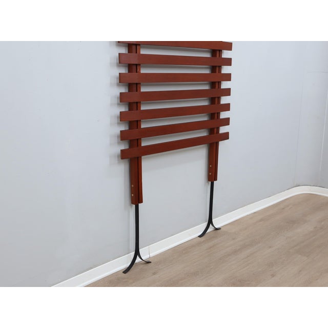 Elevate your entryway with a definitive piece of 1950s italian mid-century modernism. This floor-to-ceiling coat rack,...