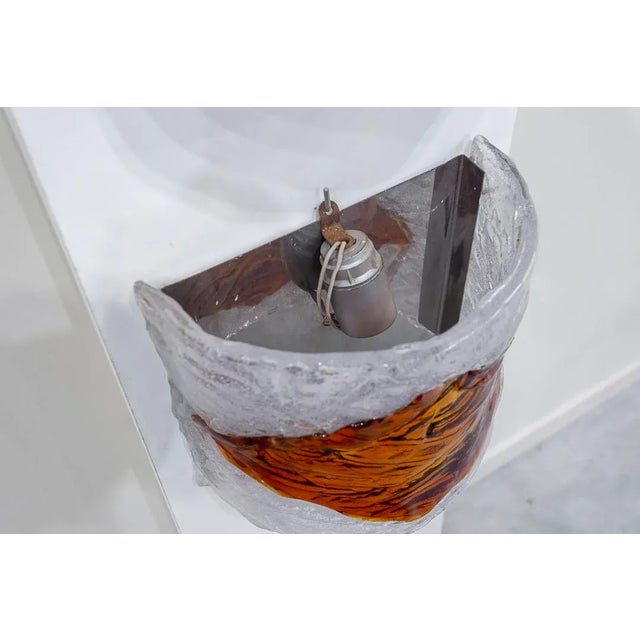 Pair of transparent frosted glass wall sconces with central rhombus in amber glass. Rear steel support and crescent-shaped...