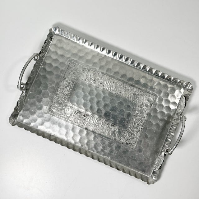 This 1950s Aluminum Serving tray is hand-wrought and etched with botanicals leaves, vines and fruit. It has two large...