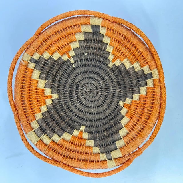 This handcrafted fruit basket comes from the Swazi people of Eswatini (Swaziland), reflecting traditional artistry and...