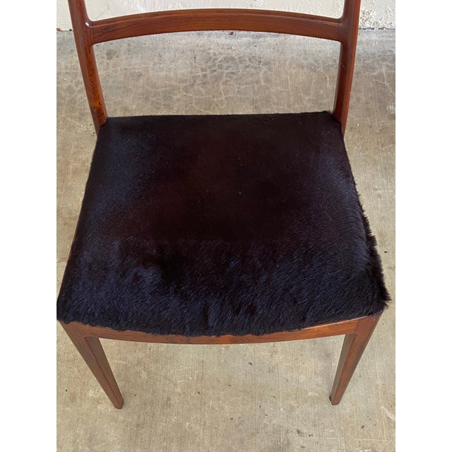 A refined and sculptural set of six Danish Modern dining chairs attributed to celebrated Danish designer Arne Vodder....