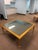 Elegant gilt coffee table featuring a mirrored glass top and clean Neoclassical lines. Hollywood Regency–inspired design...