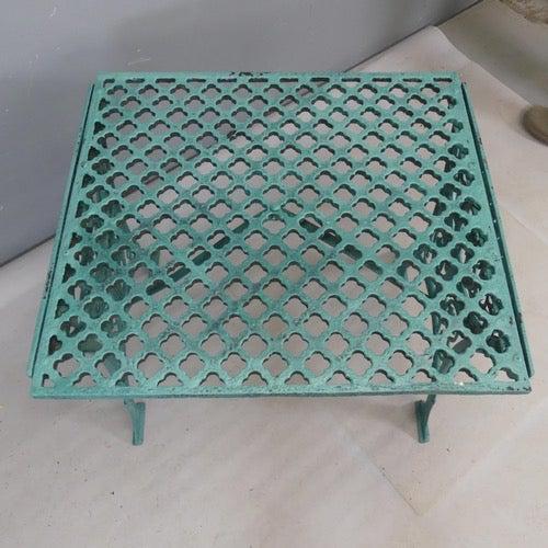 This antique wrought iron garden table, with pierced lattice design top and foliated ends, has been previously painted...