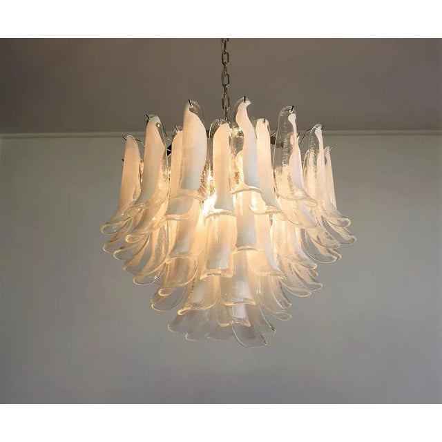 Murano Italian glass chandelier. Fantastic chandelier with trasparent and white “lattimo” glasses, nickel-plated metal...