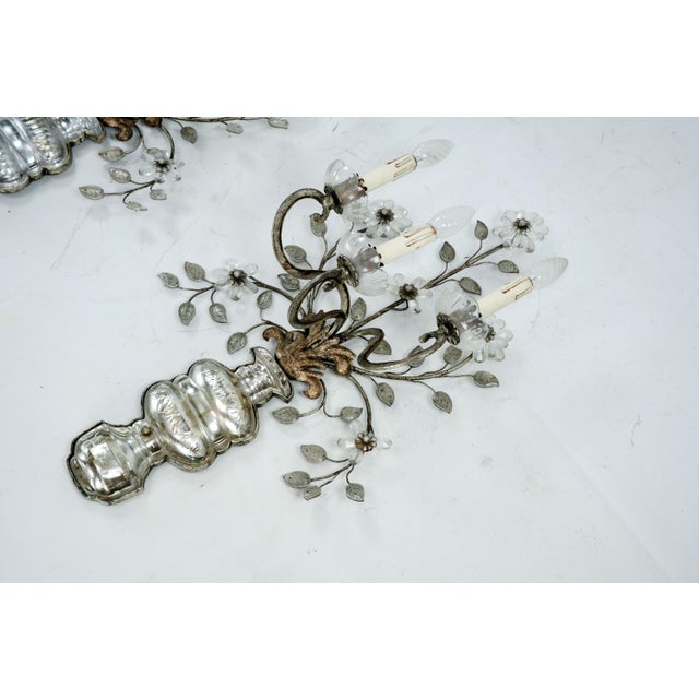 A refined pair of French wall sconces attributed to Maison Bagues, Paris, dating from the 1960s. Each three-arm sconce is...