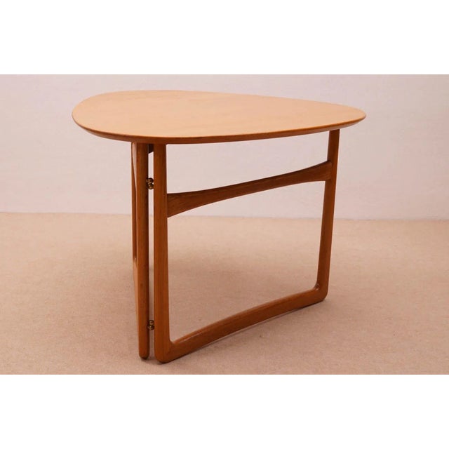 The table can be used as side table or coffee table and is easily stored or transported by its folding mechanism. By...