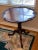 Genuine antique Chippendale round pedestal table with fold-down top. Ornately hand-carved detailing around top and on legs...