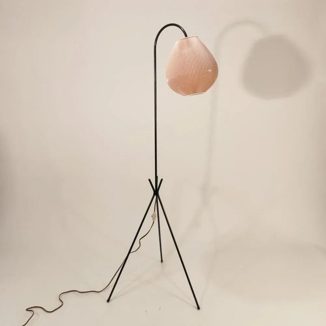 Jean Rispal's foot lamp, France Circa 1955. Black lacquered metal structure in the shape of a punching and ovoid salmon...