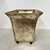 Footed planter with gold over silver wash finish. And adorned with a bronzed metal medallion of the Sun King on each side....