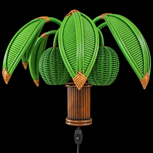 Offered is a beautiful pencil reed palm tree wall lamp attributed to Mario Torres Lopez. Two.coconuts conceal the lights....