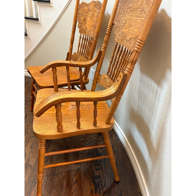 Bring timeless craftsmanship and warm character to your home with this beautiful vintage pair of solid oak pressed-back...