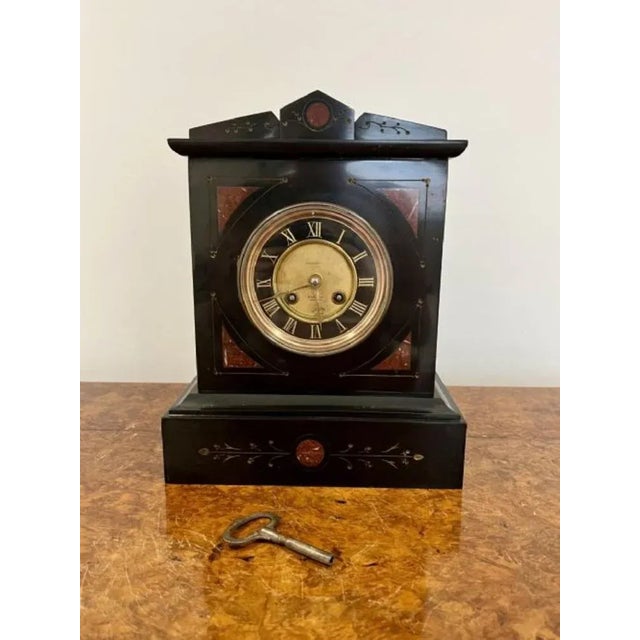 Antique Victorian quality marble clock having a quality black marble clock with a 8 day French movement striking the hour...