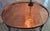 19th century French elliptical table with copper insert top. Four shaped metal legs terminating in metal masks. Shaped...