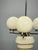 Striking Art Deco chandelier produced in Czechoslovakia during the 1930s, combining cream opaline glass with a sculptural...