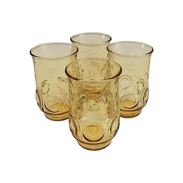 Vintage set of four stylish gold textured thumbprint juice glasses. Unmarked. Condition: Excellent Dims: 2.45" Dia x 3.65" H.
