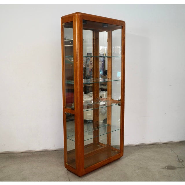 Vintage 1970's Midcentury Modern glass display cabinet for sale. It's really well made, and was manufactured here in the...