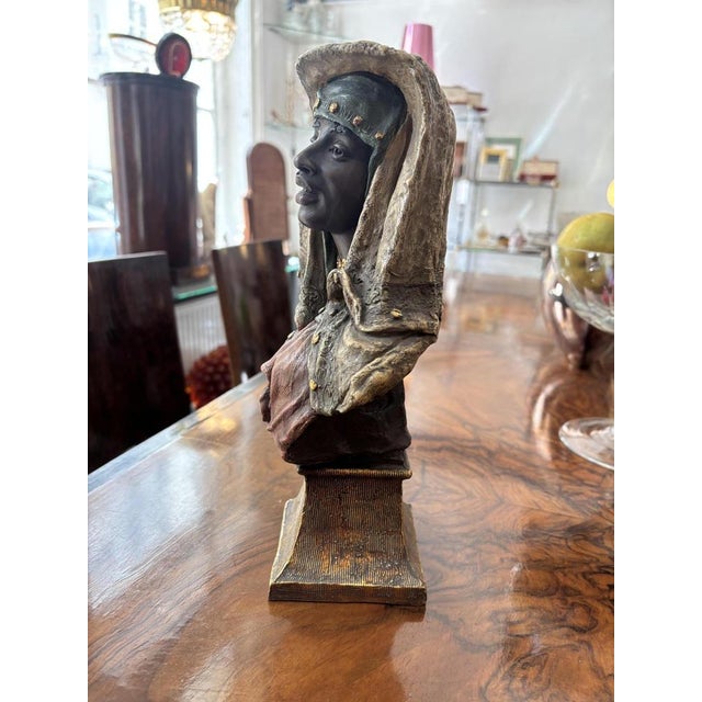 Oriental terracotta bust of a girl from the 20th century, Goldscheider The bust is polychrome painted and depicts a young...