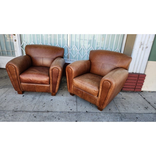 Classic brown leather club chairs from Thomasville. These chairs feature a cognac-colored top-grain leather upholstery...