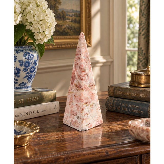 A beautifully proportioned marble obelisk in richly veined shades of pink and cream. The sculptural silhouette and...