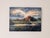 This artwork depicts a serene sunset over the Saint Michel House, illuminated by warm, golden light that casts a tranquil...