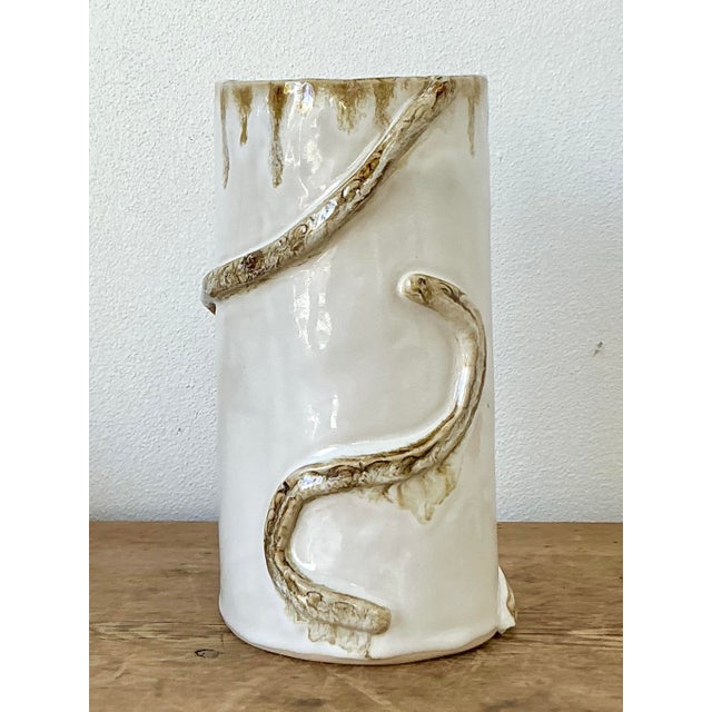 This original studio pottery vase is a compelling example of organic modernism, showcasing a hand-sculpted serpentine...