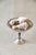 A footed silverplate compote with a wide, shallow bowl on a turned stem. Fill it with fruit or sweets on a buffet, or...