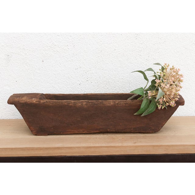 Carved from a single, massive log of hardwood, this antique wooden trough was likely originally used in a village setting...