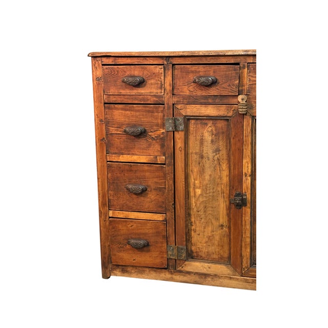 Antique fir wood shop cabinet dating back to the early 1900s, featuring 10 drawers and two doors. Designed for commercial...