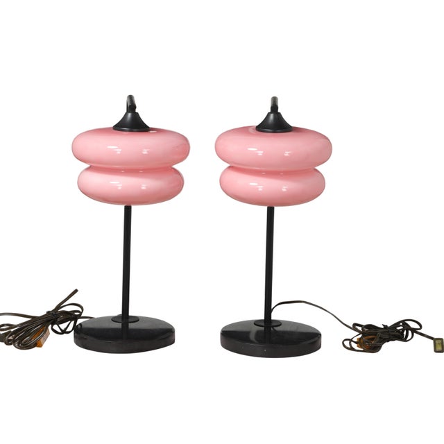 A pair of stunning pink art glass shades inspire these beautiful table lamps. Iron stems with black onyx bases. They've...