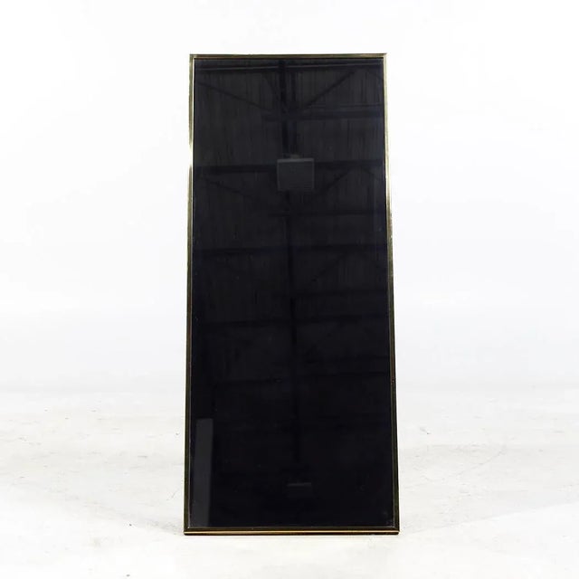 Paul McCobb for Calvin Mid Century Brass Framed Mirror This mirror measures: 20.25 wide x 1.25 deep x 48.5 inches high...