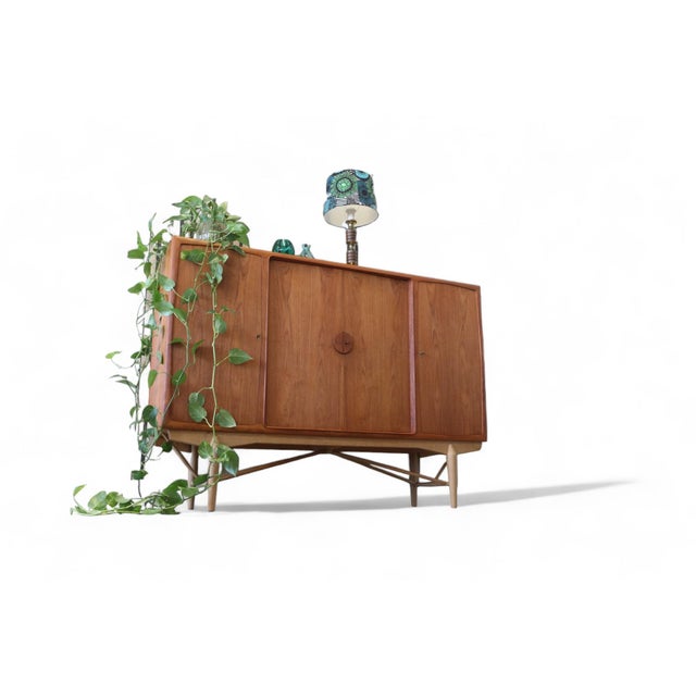 An incredibly well-built and beautiful Dansk cabinet! The cabinet is in teak with tasteful oak legs. The cabinet has four...