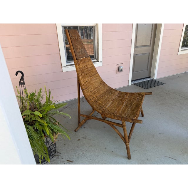 Mid-century Mexican Scorpion chair with a dramatic high back and handwoven natural fiber seat. It's sculptural silhouette,...
