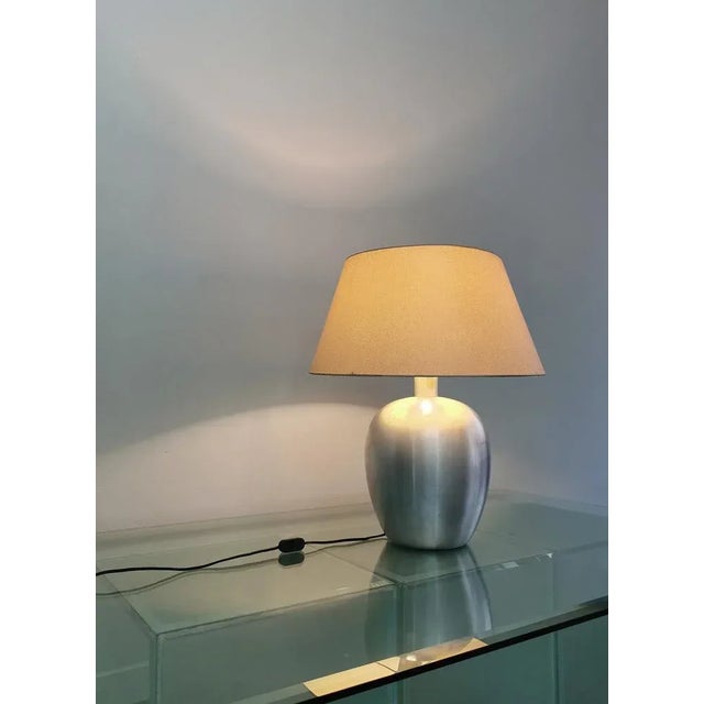 1 E27 light table lamp produced in Italy in the 70s. The lamp was made of brushed aluminum with fabric lampshade. No tear....