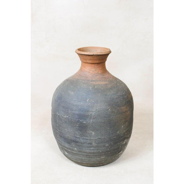 Unearth the past with this antique Asian rice wine clay container, a testament to the craftsmanship of a bygone era. Its...