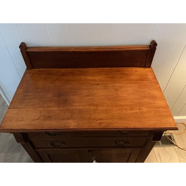 Early20 century solid oak piece, with 2 drawers and lower cabinet. There is a backsplash, so was orinally used as a...