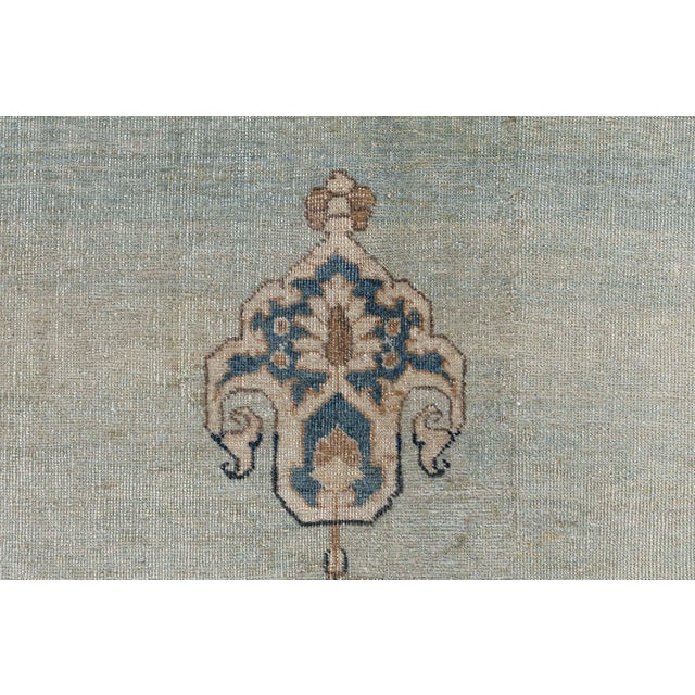 An early 20th century Persian Tabriz antique rug, the open pale field surround concentric cusped medallions with floral...