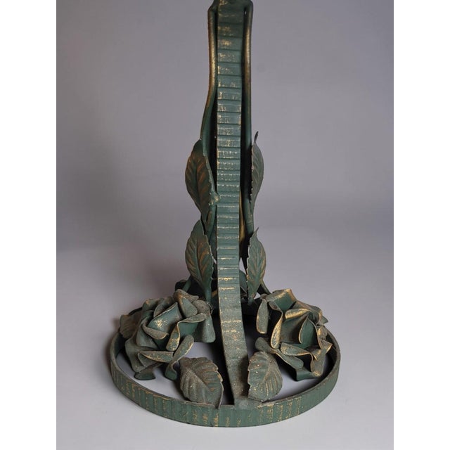 Art Deco table lamp from the 1920s-1930s. The wrought iron base has a green patina highlighted with gold. It is formed by...